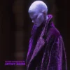 Numb Expression - A surreal music album cover featuring a figure with a cracked white head and a purple velvet coat.